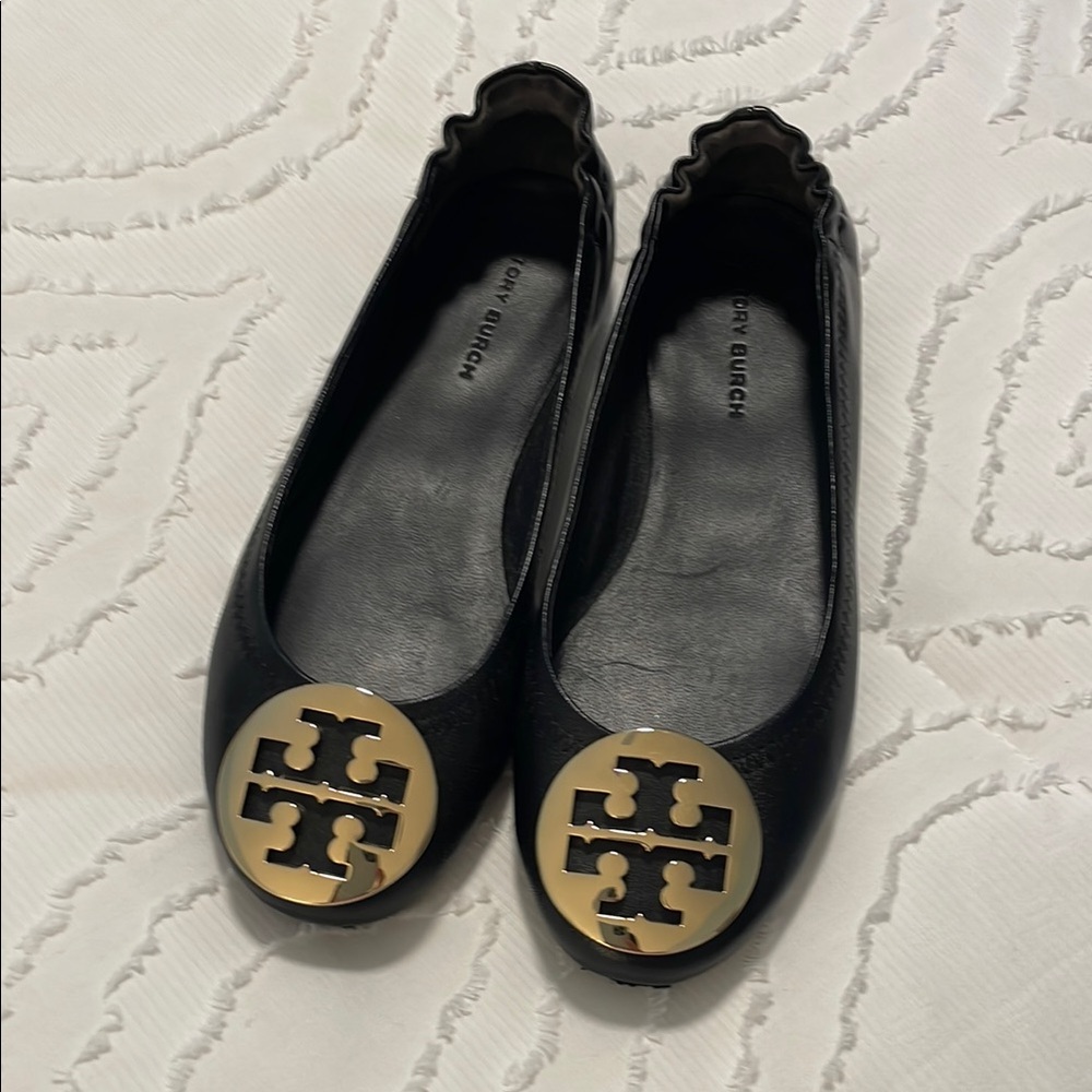 Tory Burch Black and Gold Flats with Logo Medallion